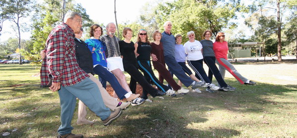 A group of people jazz dancing in the park