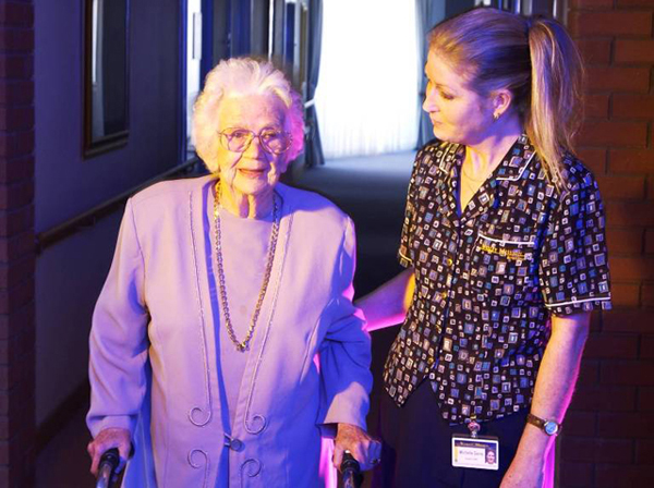 A nurse assisting a patient with walking