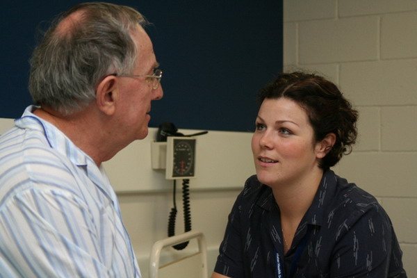 A patient listening to a nurse