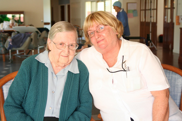 Nurse sitting down with a patient